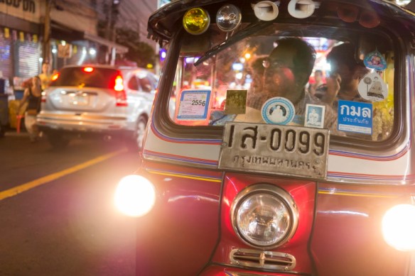 Tuk Tuk, an auto rickshaw a Bangkok, Thailand street at night.